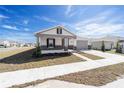 Attractive single-story home featuring a covered porch, well-kept lawn, and attached two-car garage at 5589 Sw 78Th Ave Rd, Ocala, FL 34474