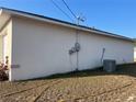 Side exterior of the home, showcasing the utility boxes and the air conditioning unit at 61 Pecan Drive Loop, Ocala, FL 34472