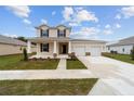 Charming two-story home with a welcoming front porch, a two-car garage, and landscaped front yard at 7821 Sw 55Th Ln, Ocala, FL 34474