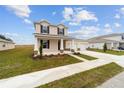 Charming two-story home with a welcoming front porch, a two-car garage, and landscaped front yard at 7821 Sw 55Th Ln, Ocala, FL 34474