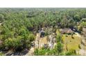 Beautiful aerial view of a home nestled among lush green trees in a wooded area at 8981 Sw Sw 209Th Cir, Dunnellon, FL 34431