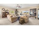 Spacious living room with neutral tones, lots of natural light, and comfortable seating at 9483 Sw 90Th St, Ocala, FL 34481