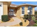 Inviting front entrance features a stone walkway and well-manicured landscaping leading to the front door at 10003 Sw 90Th Loop, Ocala, FL 34481