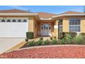 Charming single-story home with a well-maintained lawn, a two-car garage, and colorful rock landscaping at 10003 Sw 90Th Loop, Ocala, FL 34481