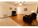 Cozy living room features wood floors, neutral walls, ceiling fan and nice natural lighting at 10498 Sw 99Th Ave, Ocala, FL 34481