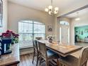 Dining room features wood floors, pendant lighting, and a large window at 1083 Se 65Th Cir, Ocala, FL 34472