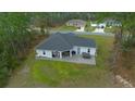 Aerial view of home's backyard featuring a covered patio with furniture, a grill, and a hot tub at 13105 Sw 73Rd Avenue Rd, Ocala, FL 34473