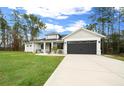 Well maintained single-story home features manicured front yard, a gray garage door, and welcoming curb appeal at 13105 Sw 73Rd Avenue Rd, Ocala, FL 34473