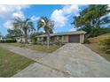 Well-maintained home featuring an attached garage and spacious driveway at 15052 Sw 43Rd Terrace Rd, Ocala, FL 34473