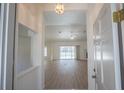 Bright living room with wood floors, high ceilings and sliding glass doors leading to the pool area at 1712 Ne 40Th Ave, Ocala, FL 34470