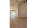 Living room with tile flooring leading to a dining area and patio doors at 3940 Sw 138Th Pl, Ocala, FL 34473