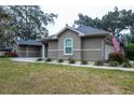 The side of the home features neutral stucco and decorative landscaping that adds to the property's curb appeal at 4604 Se 33Rd Pl, Ocala, FL 34480