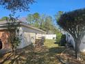 Backyard view showing the fence line, siding, storage area, and a glimpse of the home's exterior features at 5155 Sw 39Th St, Ocala, FL 34474