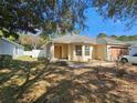 Inviting single-story home with a well-kept lawn, complemented by mature trees and shrubs at 5155 Sw 39Th St, Ocala, FL 34474