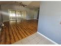 Spacious living room featuring ceiling fans, hardwood floors, and a sliding glass door for natural light at 5155 Sw 39Th St, Ocala, FL 34474