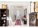 Bright entryway featuring tile flooring, coat closet, and decorative furnishings at 6188 Sw 84Th St, Ocala, FL 34476