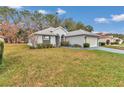 Lovely single-Gathering home with a vibrant green lawn, complemented by a driveway and an attached two-car garage at 6793 Sw 111Th Loop, Ocala, FL 34476