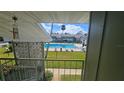 View of the fenced in pool area from the second story of a condo at 840 Center Ave # 98, Holly Hill, FL 32117