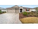 Inviting single-story home with manicured landscaping and a spacious driveway at 9276 Sw 89Th St Rd, Ocala, FL 34481