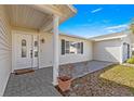 Covered front entrance with decorative door and tiled entryway at 9884 Se 175Th Pl, Summerfield, FL 34491