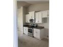 New kitchen features white cabinets, modern appliances and a contrasting countertop at 120 Dogwood Drive Cir, Ocala, FL 34472