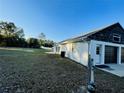 View of the garage with black doors and surrounding grassy yard at 15040 Sw 29Th St, Ocala, FL 34481