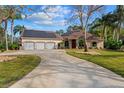 Well-maintained home featuring a three-car garage, solar panels, and landscaped front yard at 32 Allenwood Look, Ormond Beach, FL 32174