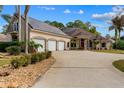 Spacious home with three-car garage, solar panels, and a long driveway at 32 Allenwood Look, Ormond Beach, FL 32174