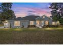 The home's exterior is enhanced by its lush lawn and landscaping, creating a warm and inviting atmosphere at 5297 Se 39 Loop, Ocala, FL 34480