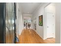 Bright foyer with gleaming wood floors, an arched doorway, and an ornate glass front door at 9581 Sw 63Rd Loop, Ocala, FL 34481