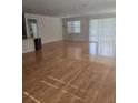 Spacious living room featuring gleaming hardwood floors and an abundance of natural light at 9581 Sw 63Rd Loop, Ocala, FL 34481