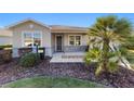 Inviting front porch with decorative shrubs and beautiful lawn at 9704 Sw 95Th Loop, Ocala, FL 34481