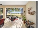 Relaxing screened porch overlooking a lush golf course, perfect for outdoor dining at 9895 Sw 95Th Loop, Ocala, FL 34481