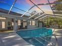 A stunning screened-in pool and deck area with a hot tub, perfect for outdoor relaxation and entertainment at 9910 Sw 189Th Cir, Dunnellon, FL 34432