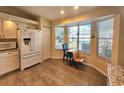 Sunlit kitchen nook with tile flooring, updated white appliances, and a breakfast table near a large window at 10823 Sw 83Rd Ave, Ocala, FL 34481