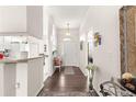 Bright entryway with white walls, hardwood flooring, and an arched doorway leading to the kitchen at 11221 Sw 71St Ct, Ocala, FL 34476