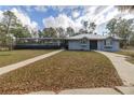 A one story home with a metal roof, covered porch and long driveway at 12330 Sw 43 St Rd, Ocala, FL 34481