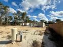 Unfinished block home framework shows construction progress with a sandy yard and bright, sunny skies at 15864 Se 98Th Ter, Summerfield, FL 34491