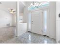 Bright foyer with decorative transom window, tile flooring, and a view of the living room at 17755 Se 117Th Cir, Summerfield, FL 34491