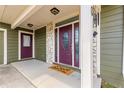 Welcoming covered front porch with stone accents, double doors and a 'Home Sweet Home' doormat at 2840 Se 35Th St, Ocala, FL 34471