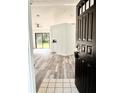 View from the doorway of a sunny living room with wood flooring, ceiling fan, and sliding glass doors at 301 Oak Track Way, Ocala, FL 34472