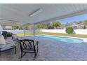 Inviting covered patio overlooking a refreshing backyard pool and green lawn at 3853 Se 60Th St, Ocala, FL 34480