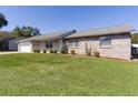 Attractive single-story brick home with a green lawn and manicured landscaping at 3853 Se 60Th St, Ocala, FL 34480