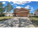 Two-story home with a two-car garage and a large driveway at 3999 Sw 51St Ct, Ocala, FL 34474