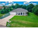 Well-kept single-Gathering home with a lush green lawn, attached garage, and inviting entrance at 4160 Sw 98Th St, Ocala, FL 34476