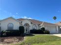 Charming single-story home featuring a well-manicured lawn, neutral tones, and attached two car garage at 5500 Nw 23Rd Pl, Ocala, FL 34482