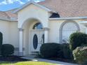 Inviting front entrance with double doors, arched entryway and manicured landscaping at 5500 Nw 23Rd Pl, Ocala, FL 34482