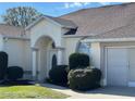 Charming single-story home featuring a stucco facade, arched entryway, and attached one-car garage at 5500 Nw 23Rd Pl, Ocala, FL 34482