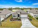 Aerial view of the home showing the nicely landscaped yard and lake views at 5728 Sw 90Th Court Rd, Ocala, FL 34481