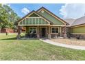 Charming home featuring a cozy front porch with rocking chairs and stone-accented columns at 5995 Se 22Nd Ave, Ocala, FL 34480